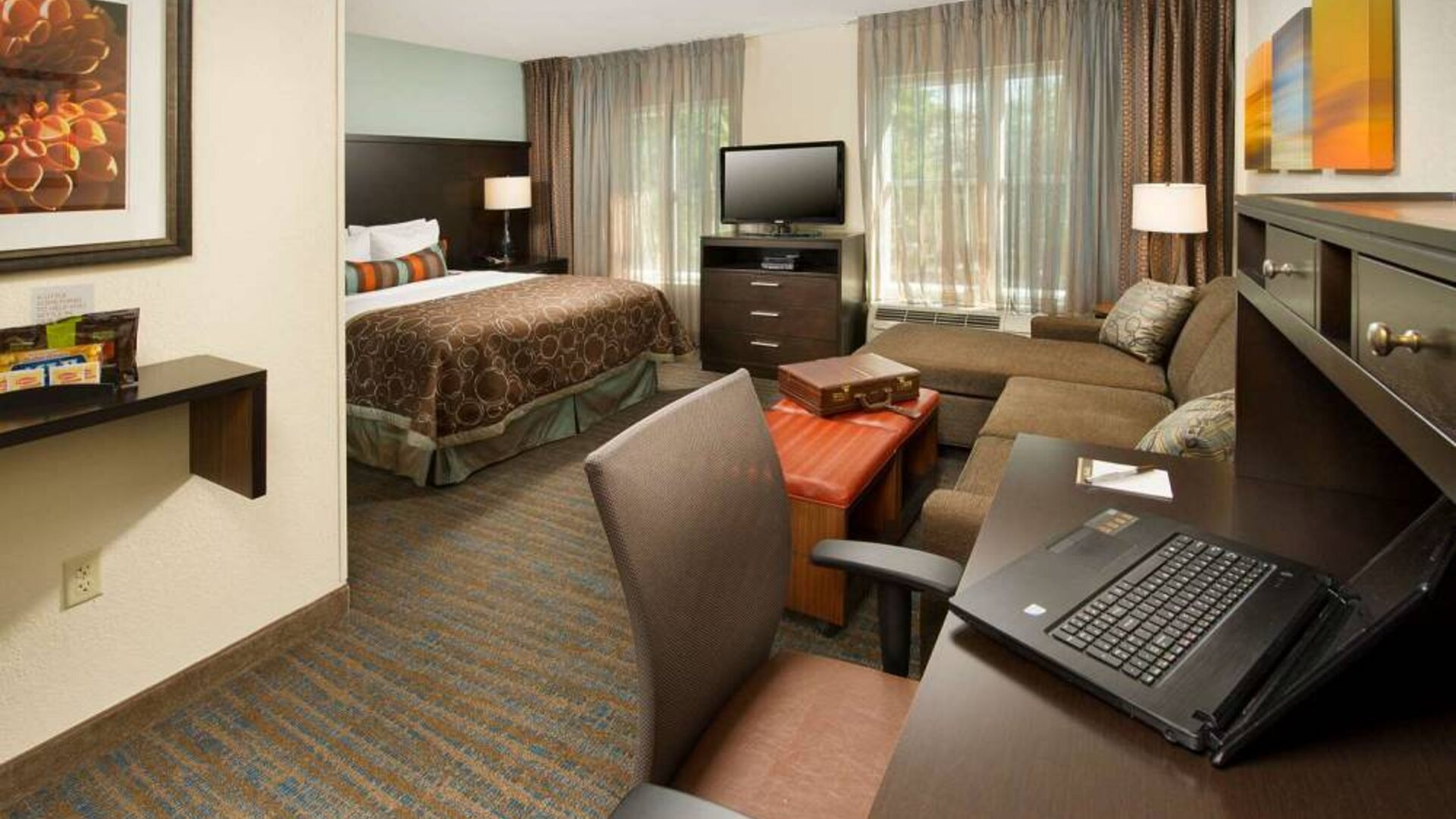Double bed guest room in Sonesta ES Suites Atlanta Alpharetta Avalon, with sofa, TV, windows, and a workspace desk and chair.