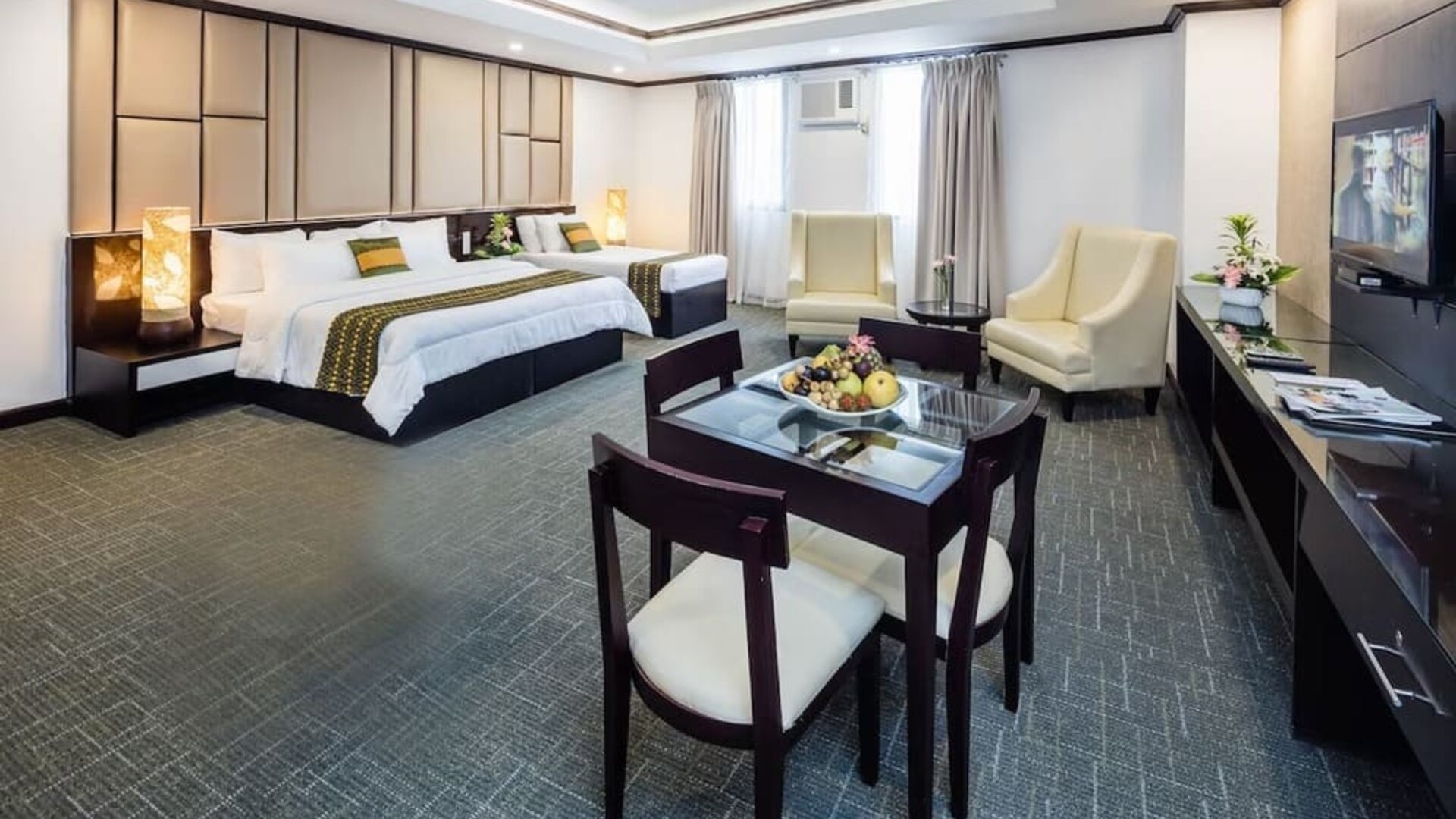 Spacious king room with dining area at Apo View Hotel.