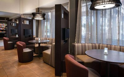 The hotel’s media pods offer a cozy space for co-working, and each has comfy seating, a coffee table, and a television.