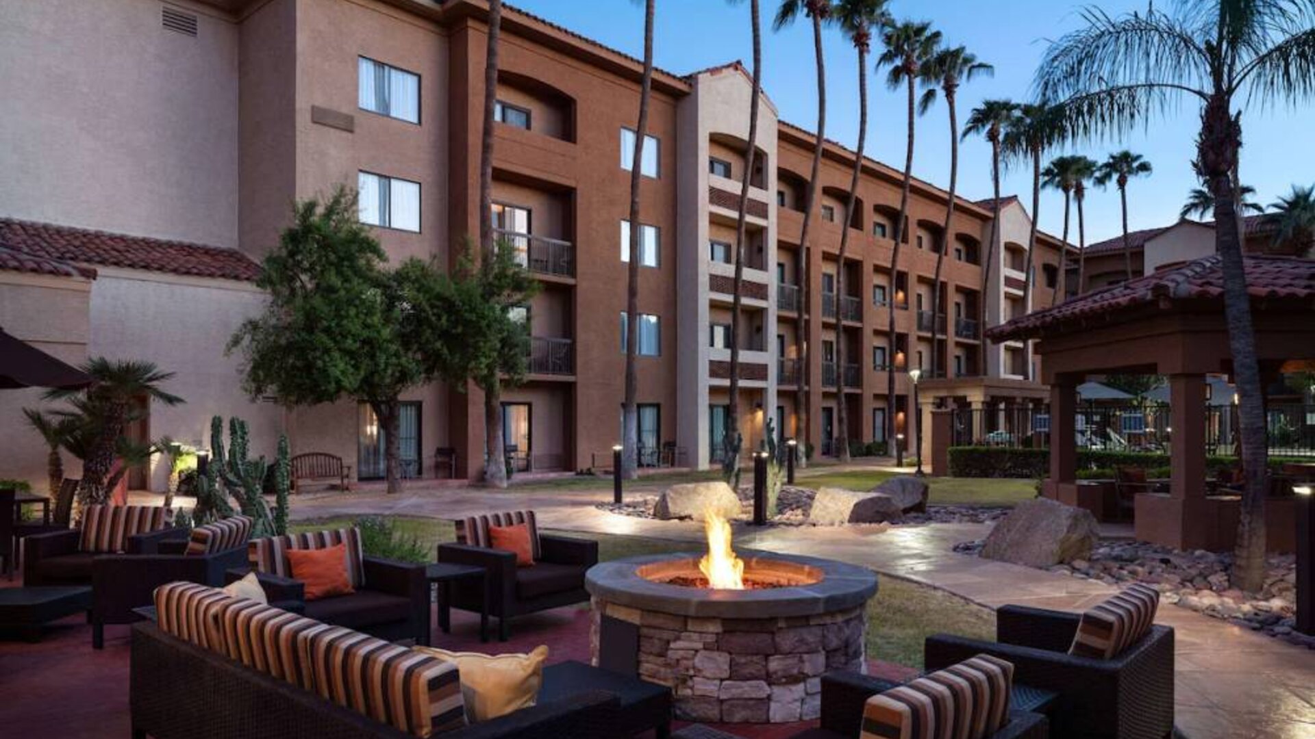 Sonesta Select Phoenix Camelback’s patio features a fire pit surrounded by armchair and sofa seating.