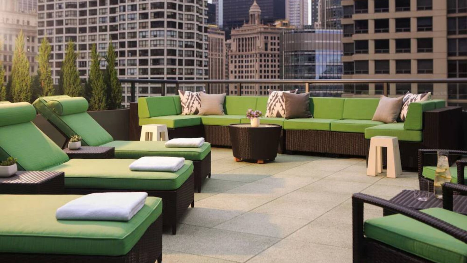 Royal Sonesta Chicago River North’s patio is furnished with chairs, loungers, and sofas, and offers city views.