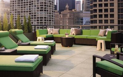 Royal Sonesta Chicago River North’s patio is furnished with chairs, loungers, and sofas, and offers city views.