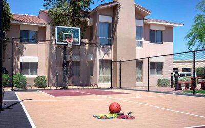 The hotel basketball court has fencing by the hoop, and can also be used for playing tennis.