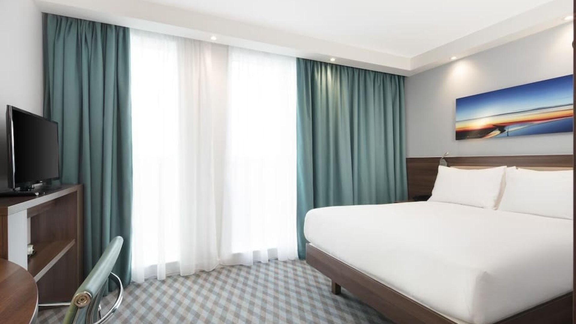 King room with TV and work station at Hampton By Hilton London Stansted Airport.