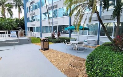 Outdoor garden and terrace at EnVision Hotel Miami International Airport.