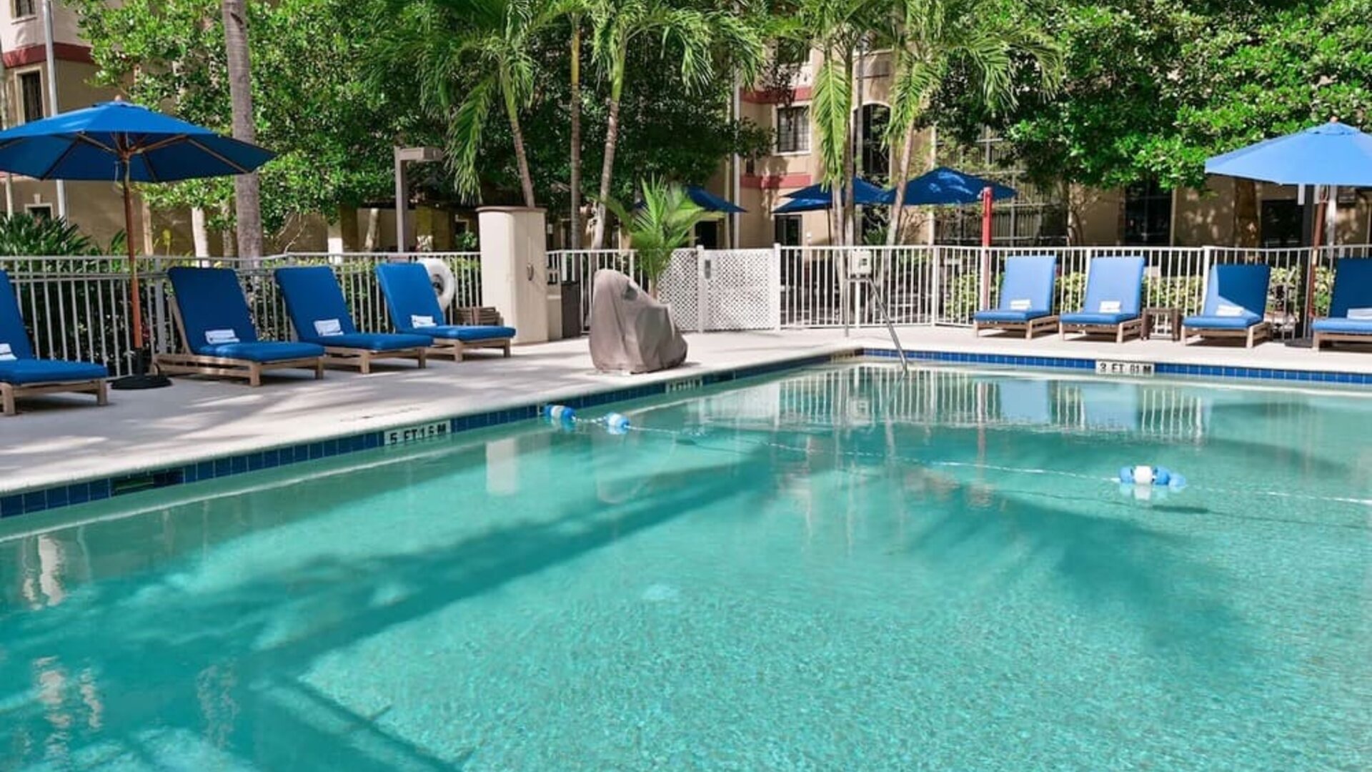 Large outdoor pool with sun lounge chairs at Sonesta ES Suites Fort Lauderdale Plantation.