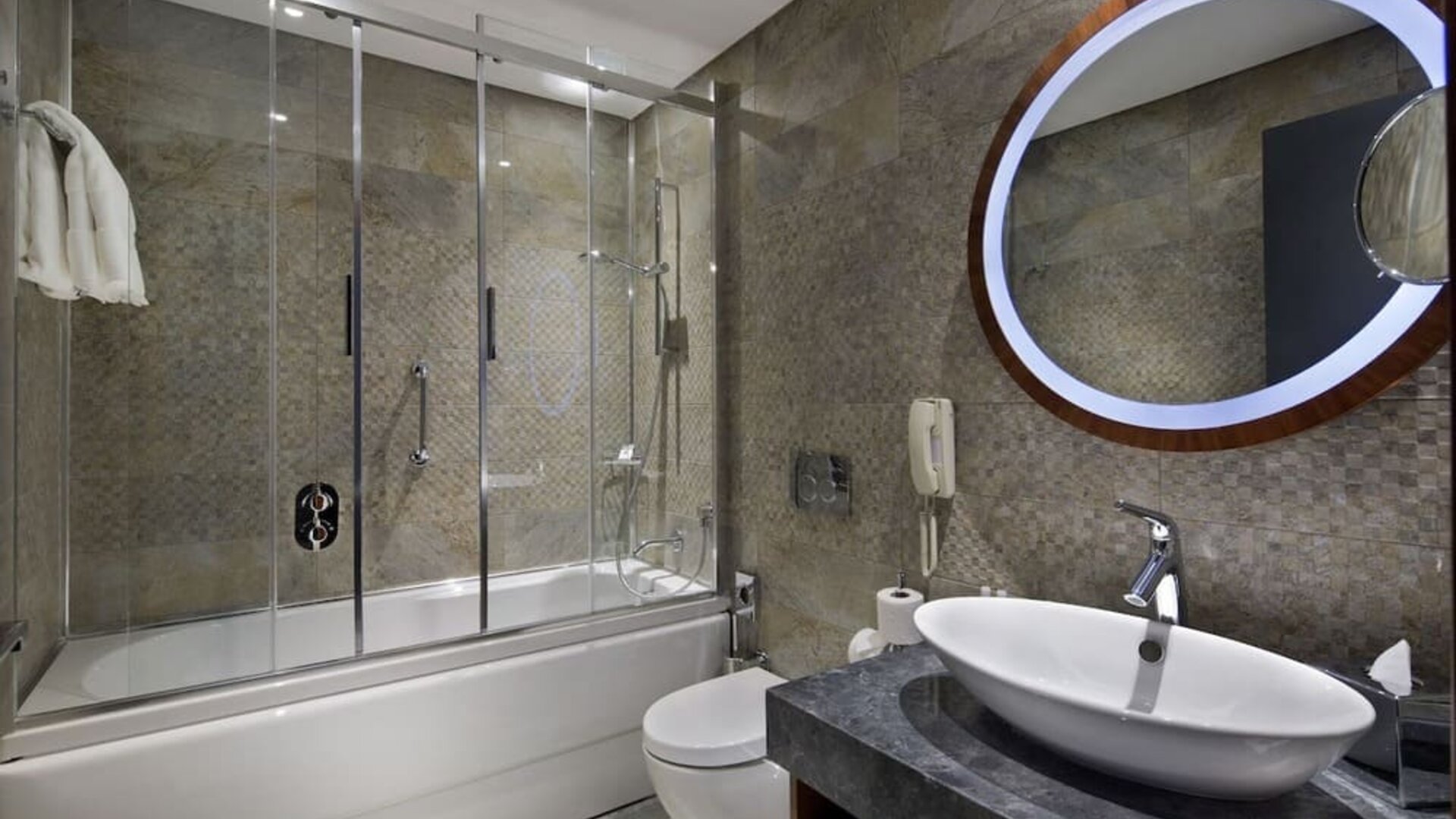 Guest bathroom with shower and bath at DoubleTree By Hilton Istanbul - Piyalepasa.