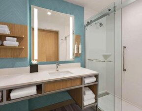 Guest bathroom with shower at Hilton Garden Inn Nashville West End Avenue.
