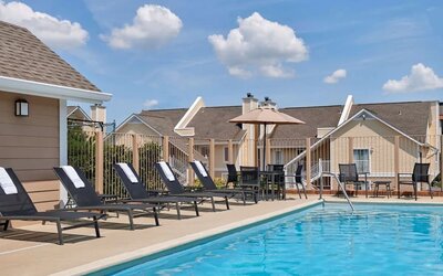 Outdoor pool with pool chairs at Sonesta ES Suites Cincinnati - Blue Ash.