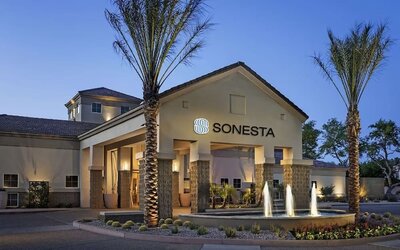 Hotel exterior and parking at Sonesta Suites Scottsdale Gainey Ranch.