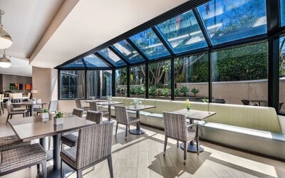Dining area with natural light at Sonesta Los Angeles Airport LAX.