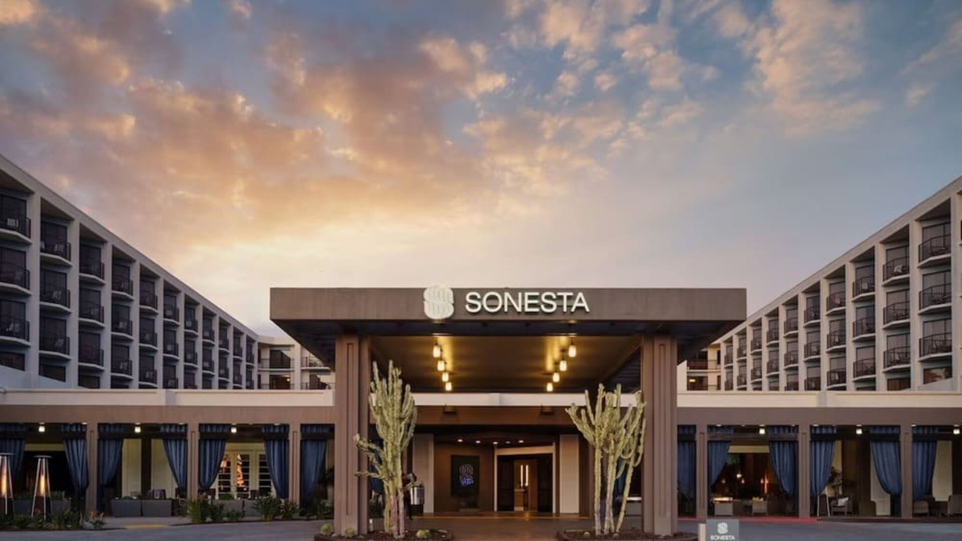 Parking and hotel exterior at Sonesta Redondo Beach & Marina.