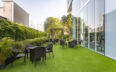 Outdoor garden with seating area at Modena By Fraser Bangkok.