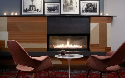 Cozy lounge with fire place at The Fifty Sonesta Select New York.