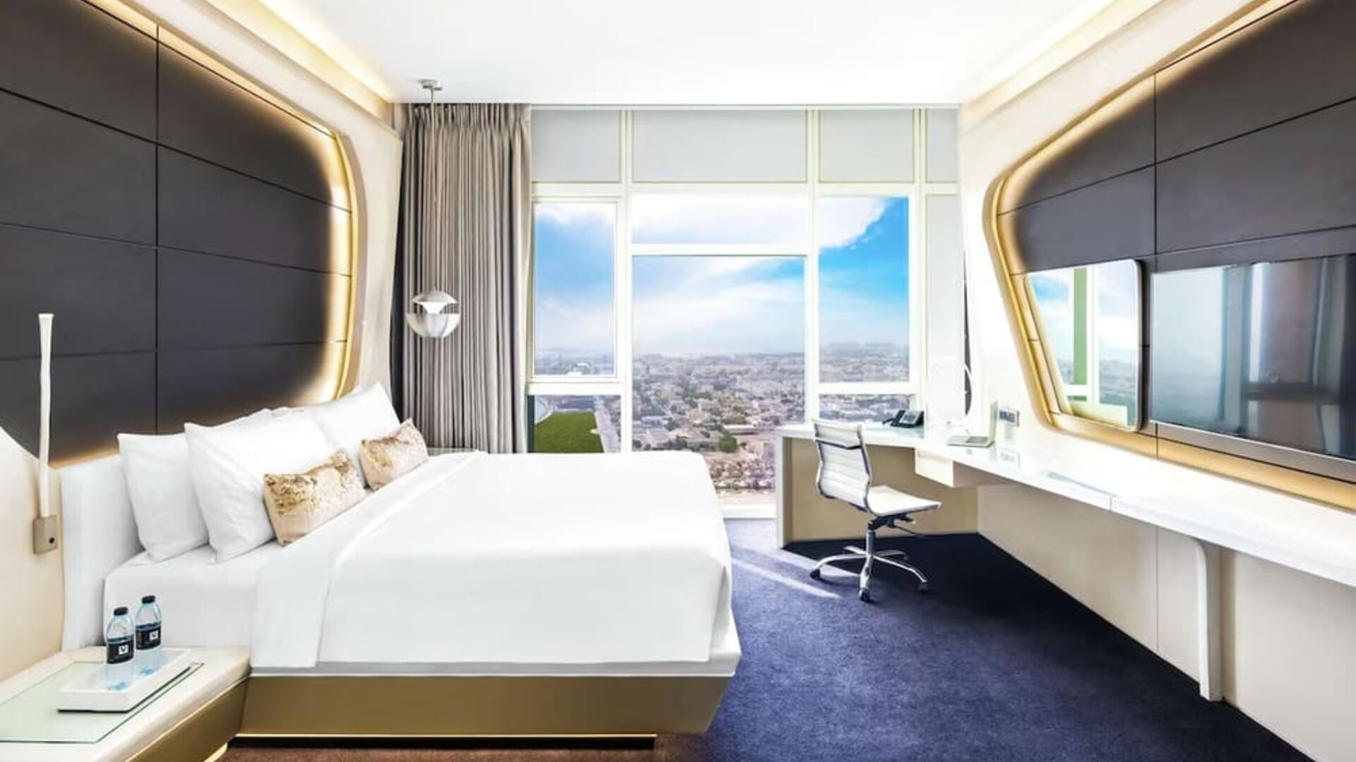 Spacious king room with TV at V Hotel Dubai.