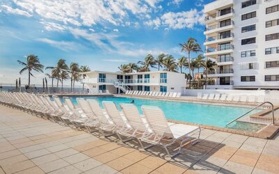 Outdoor pool and palm trees at New Point Miami.