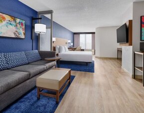 Day use room with lounge area and TV at Hyatt Place Orlando I-Drive.