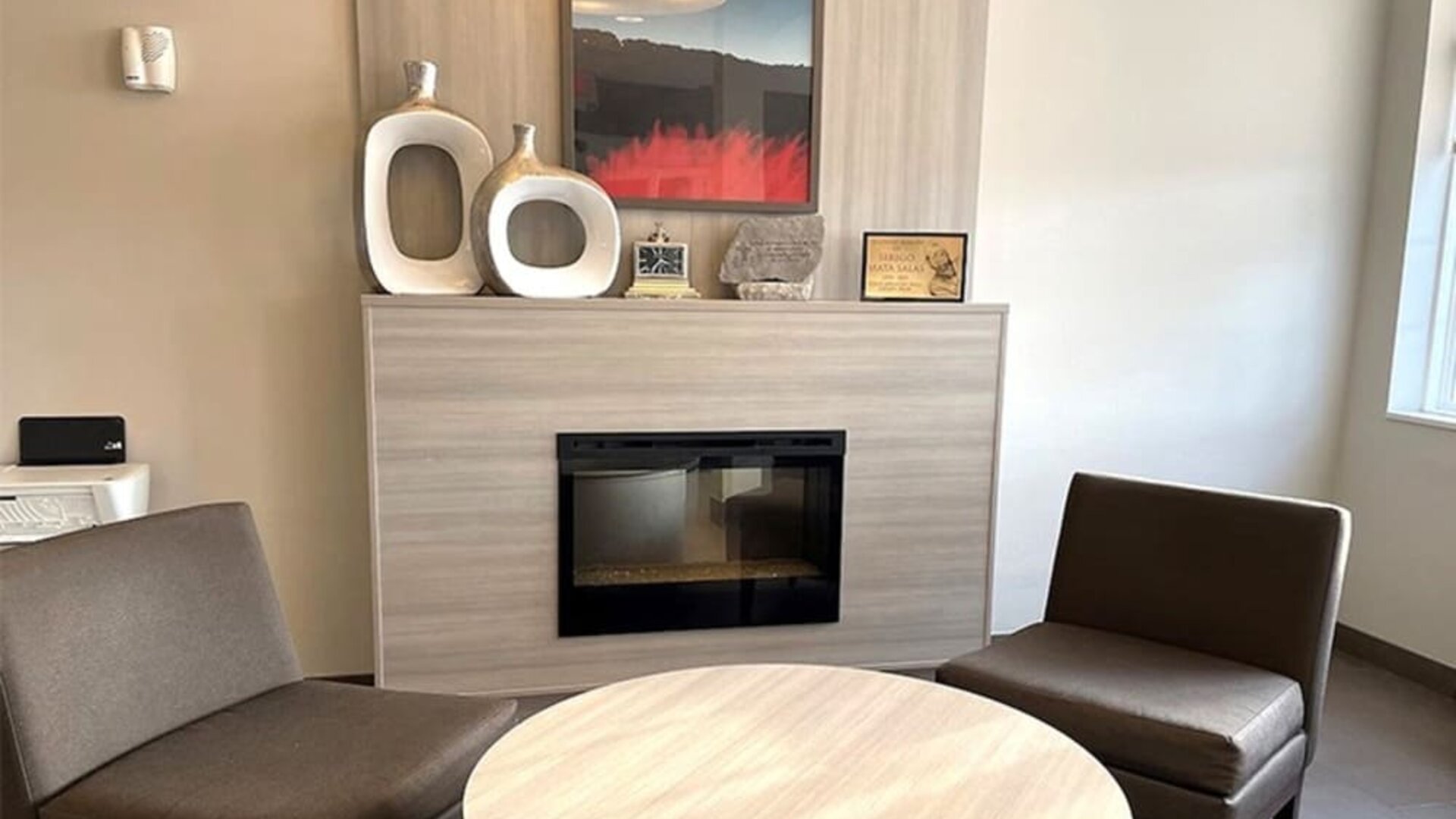 Coworking and fire place at Coratel Inn & Suites By Jasper Rochester.