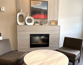 Coworking and fire place at Coratel Inn & Suites By Jasper Rochester.
