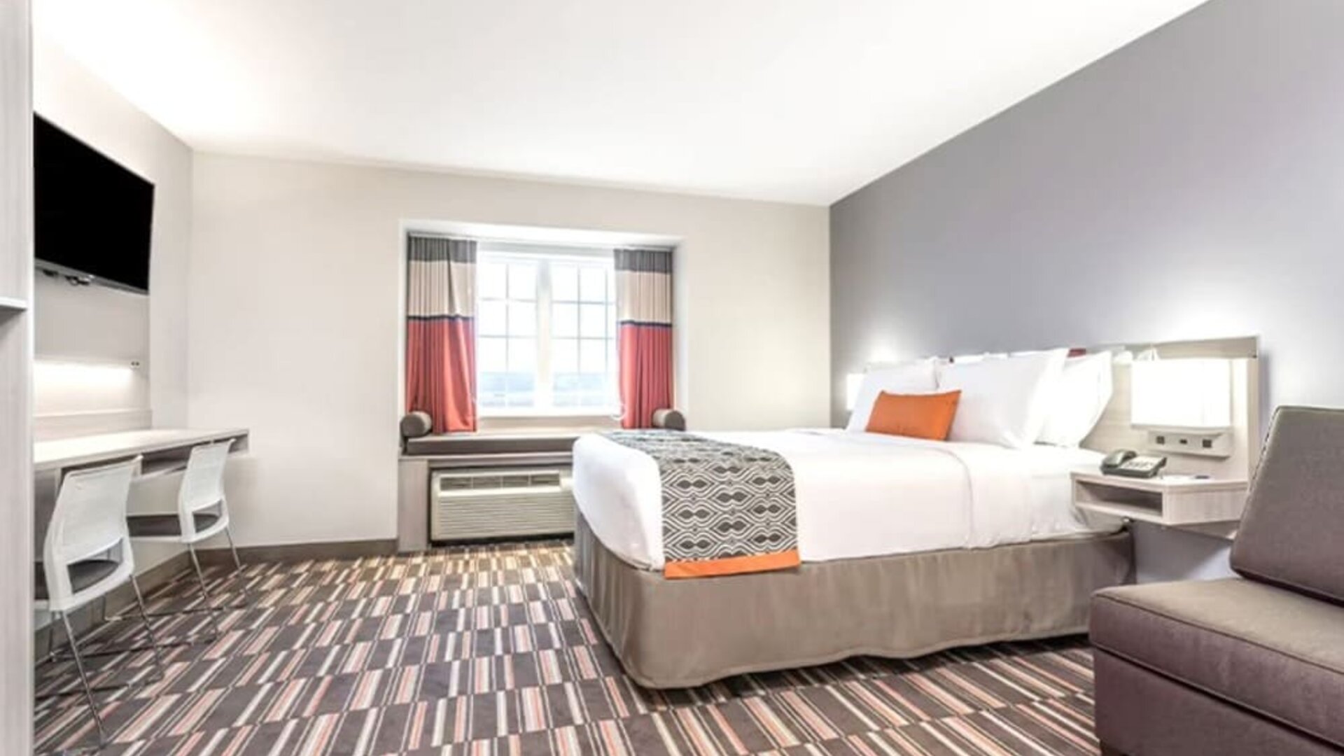 Spacious king room with TV at Coratel Inn & Suites By Jasper Rochester.
