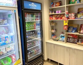 Snack bar at Coratel Inn & Suites By Jasper Rochester.
