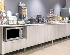 Breakfast available at Coratel Inn & Suites By Jasper Rochester.