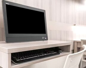 Business center at Coratel Inn & Suites By Jasper Rochester.