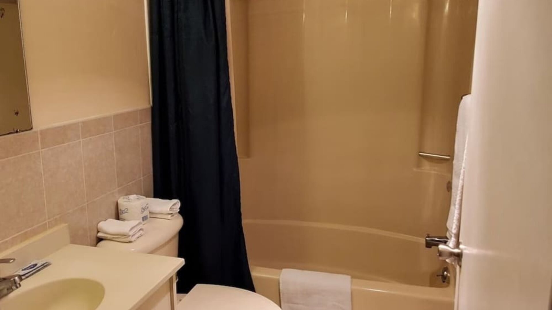 Guest bathroom with shower at Bay Breeze Motel.