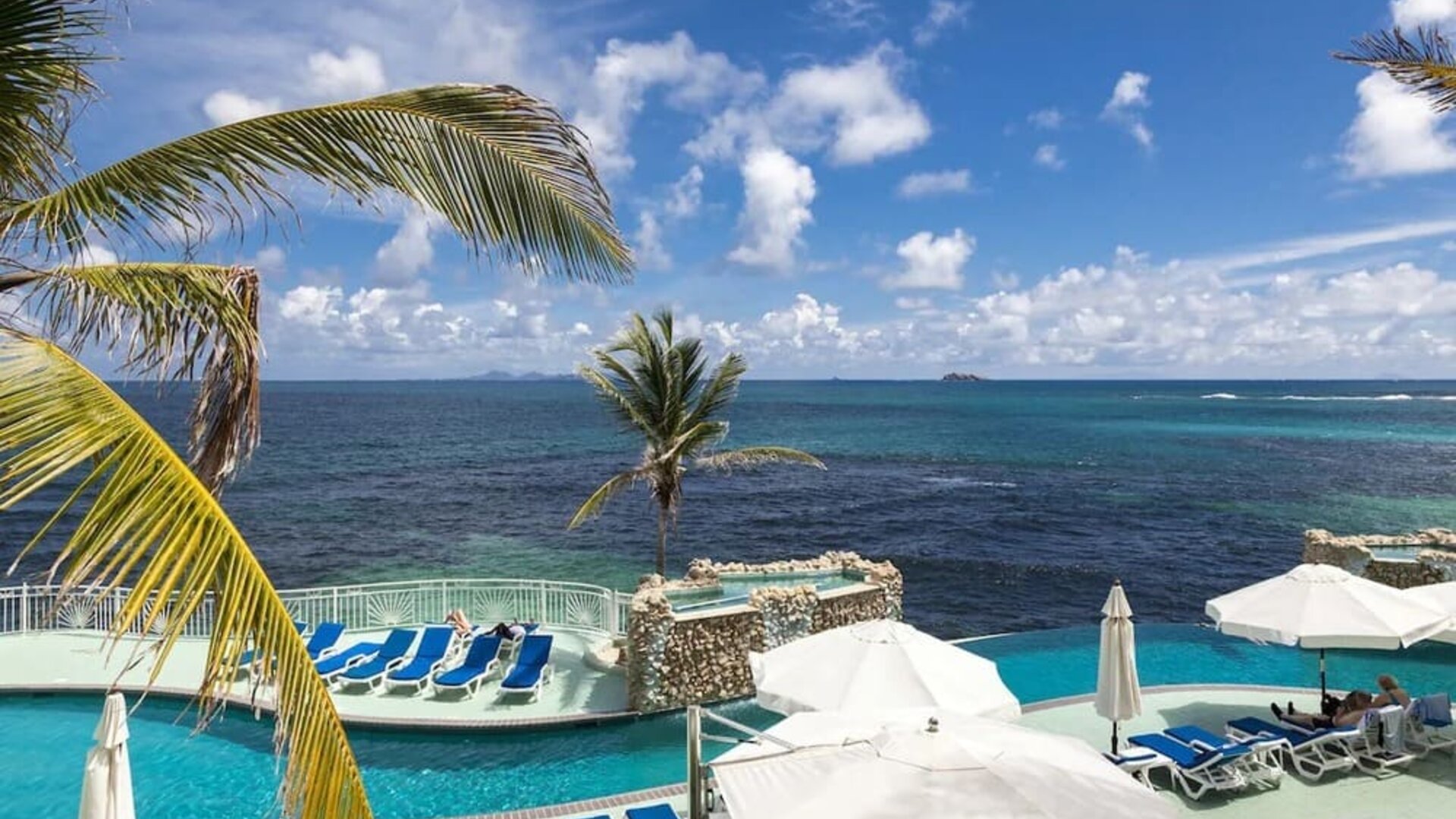 Relaxing outdoor pool and ocean view at Oyster Bay Beach Resort.
