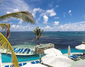 Relaxing outdoor pool and ocean view at Oyster Bay Beach Resort.