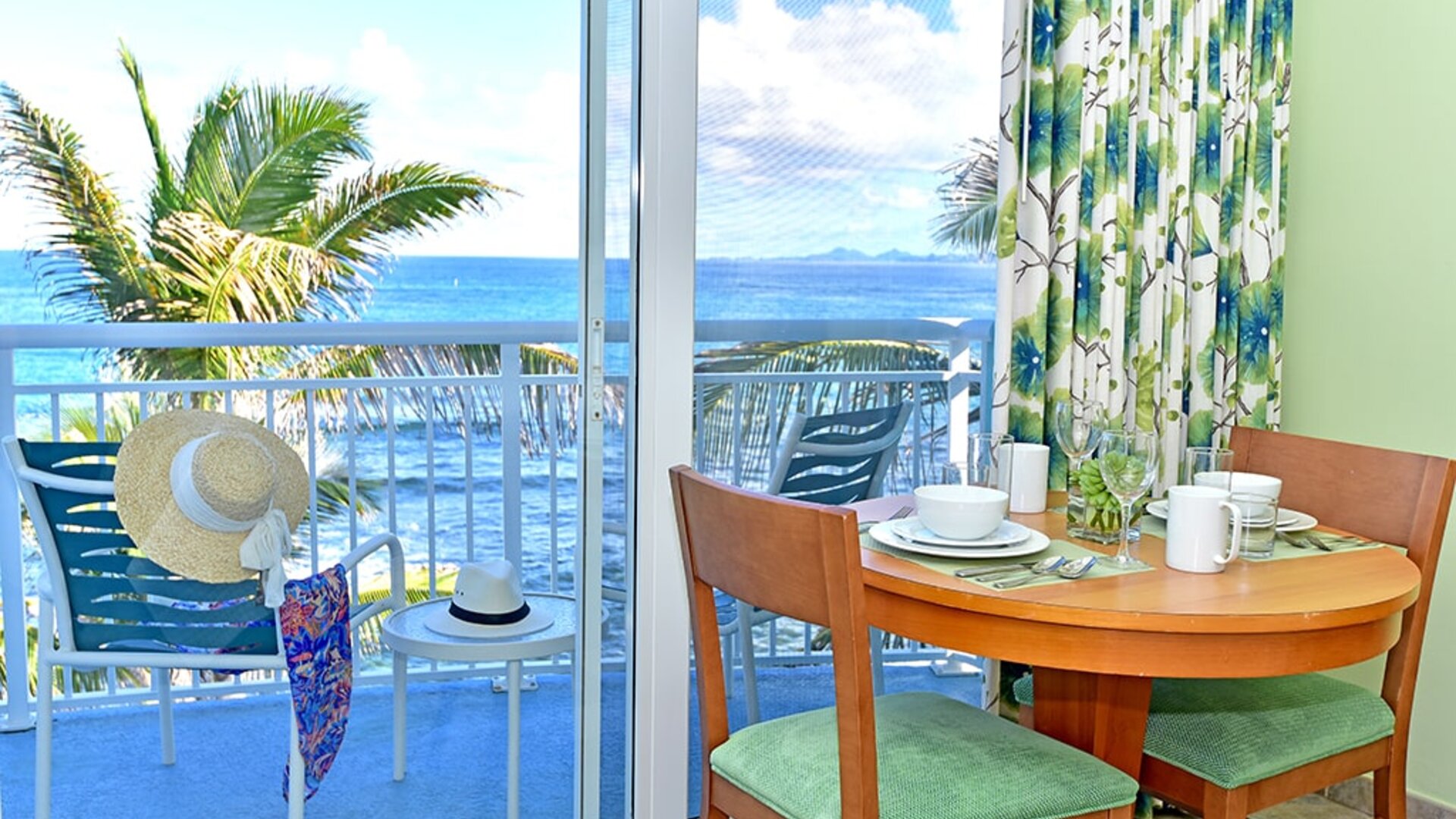 Sunset on the patio near a work desk of a day room at Oyster Bay Resort in St. Maarten.