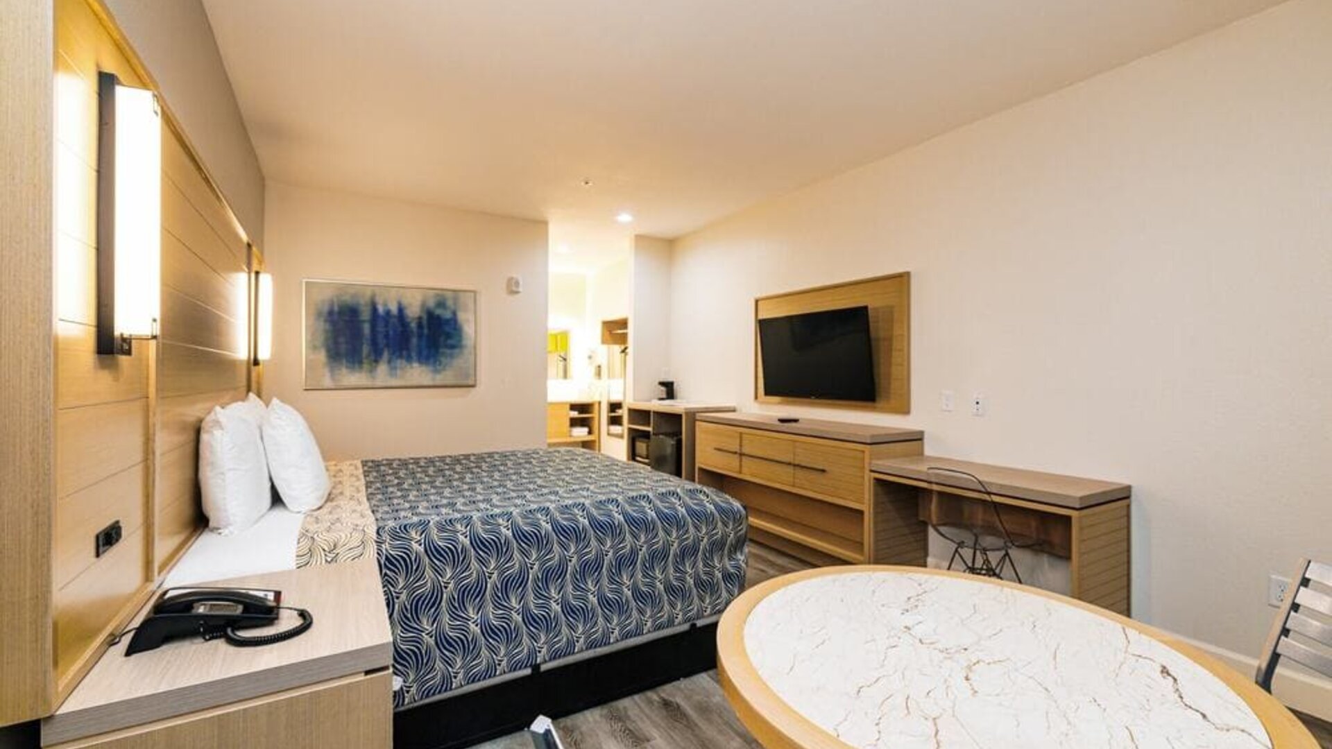 Day use room with TV and work desk at Palace Inn Blue IAH East.