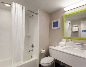 Guest bathroom with shower and tub at Hampton Inn & Suites Ft. Lauderdale Airport/South Cruise Port.