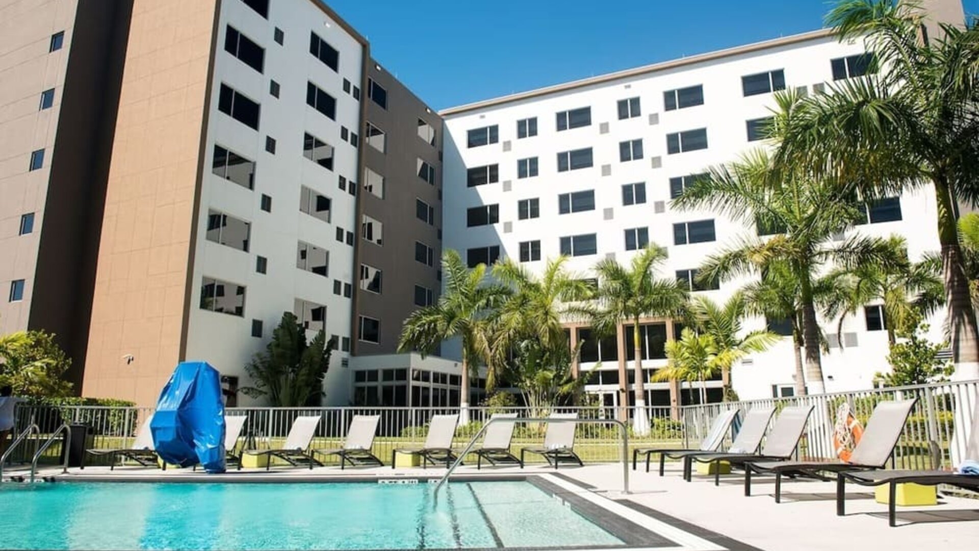 Hotel pool with loungers at Element Miami Doral.