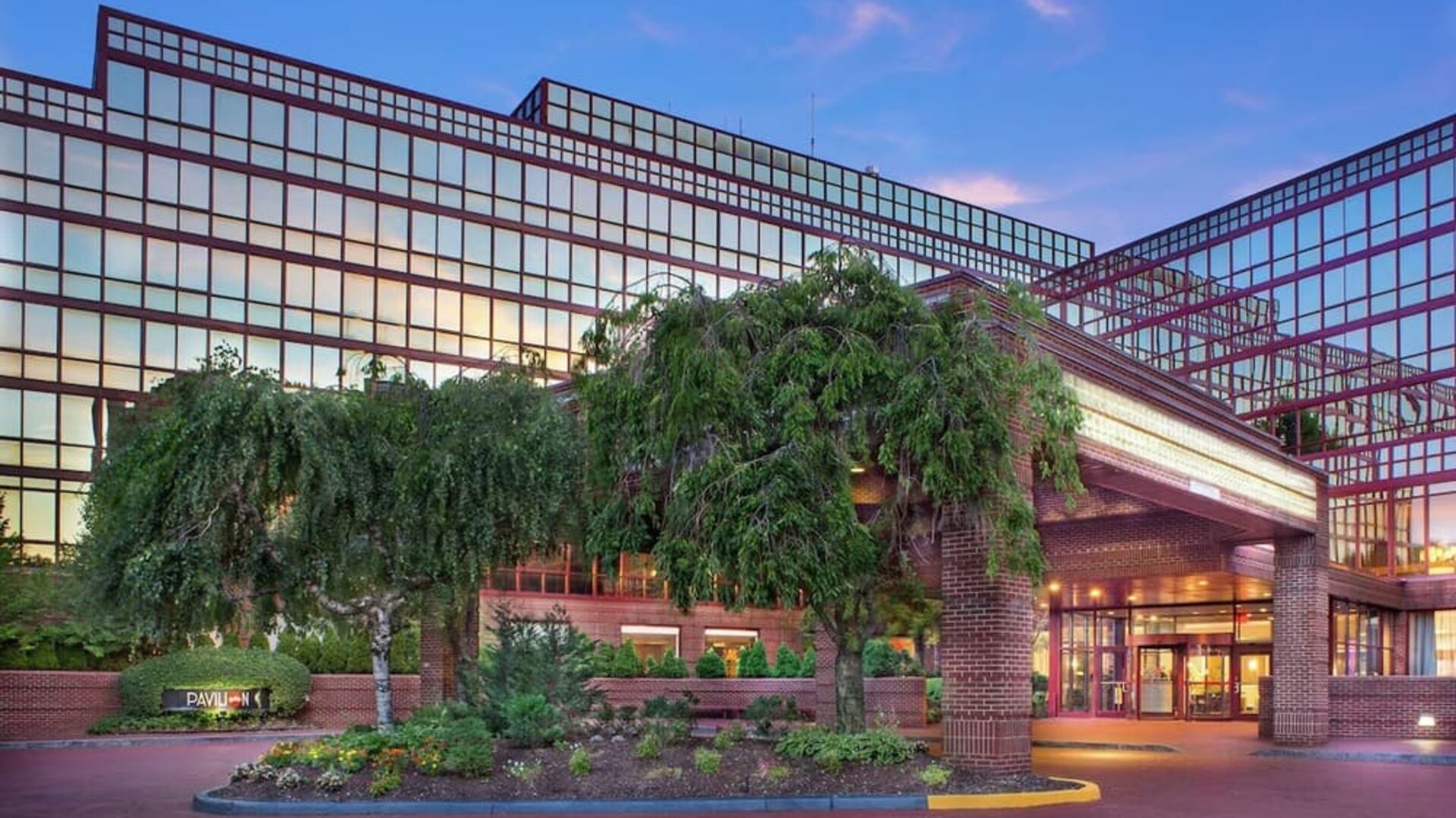 Hotel exterior and parking at Laguardia Plaza Hotel.