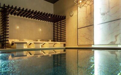 Indoor pool with chair loungers at Hilton Aberdeen TECA.