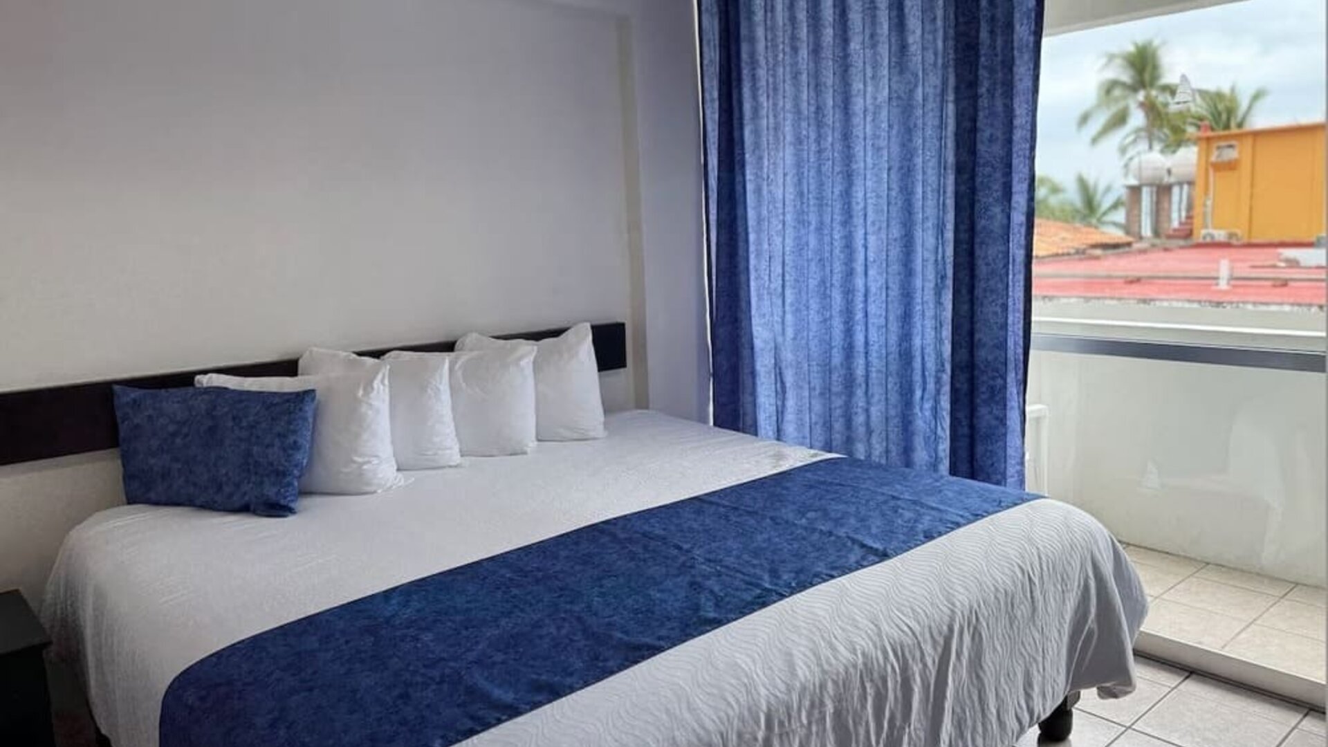 Cozy king room with terrace at Hotel Delfin PV Beach Resort.