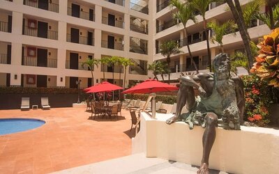 Outdoor pool and seating area at Hotel Delfin PV Beach Resort.