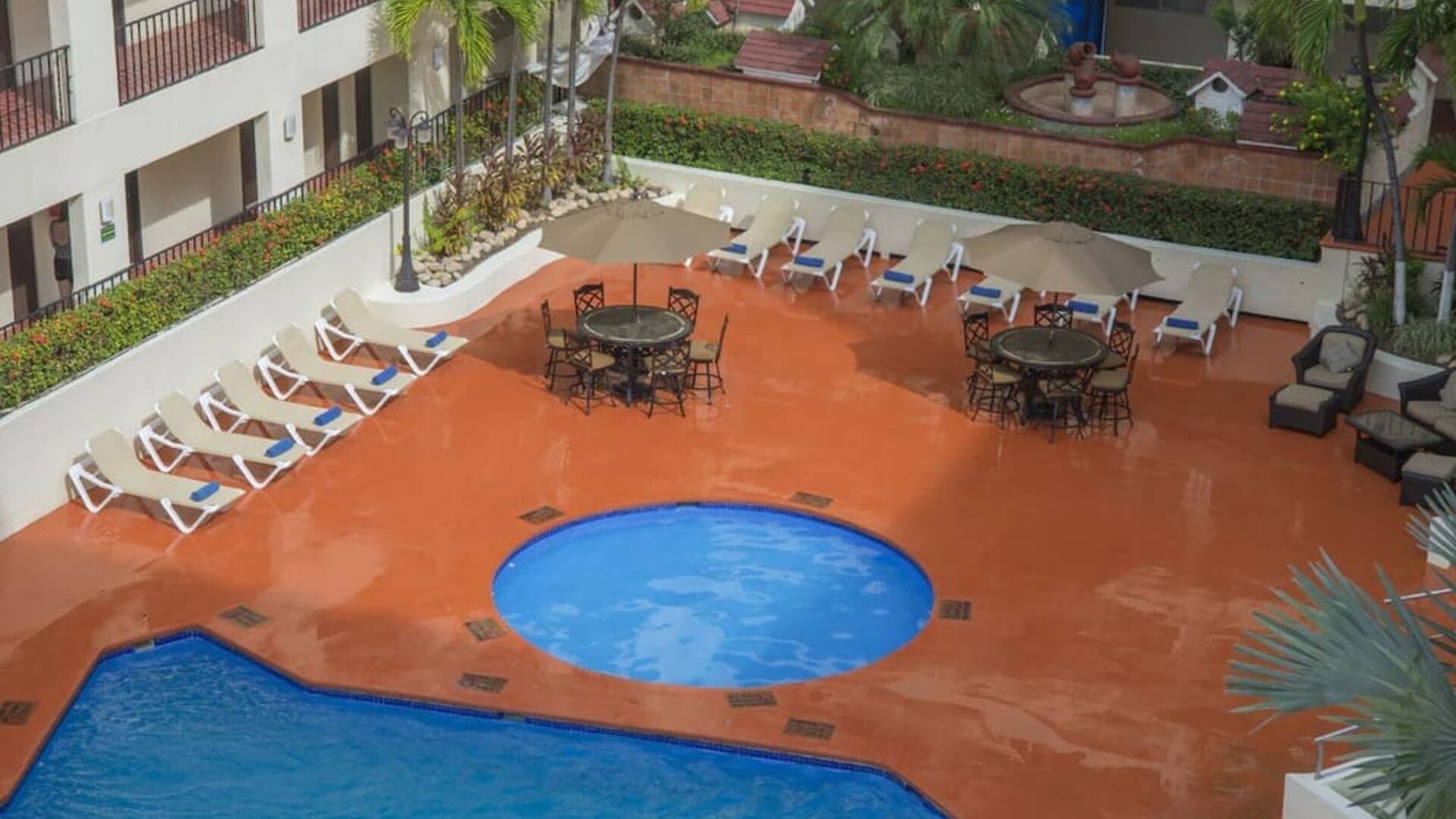 Bird's eye view of outdoor pool area at Hotel Delfin PV Beach Resort.