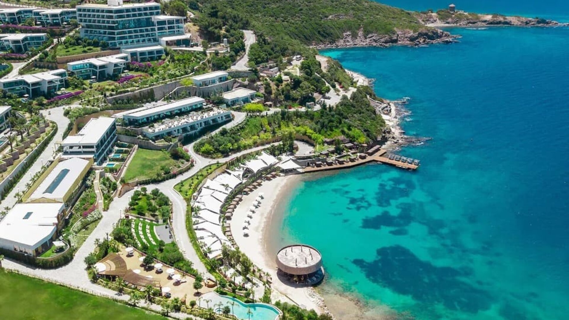 Hotel exterior and ocean view at Le Méridien Bodrum Beach Resort.