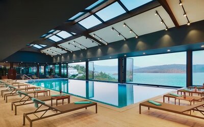 Indoor pool with loungers at Le Méridien Bodrum Beach Resort.