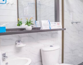Guest bathroom with shower at Montes De La Castellana Hotel.