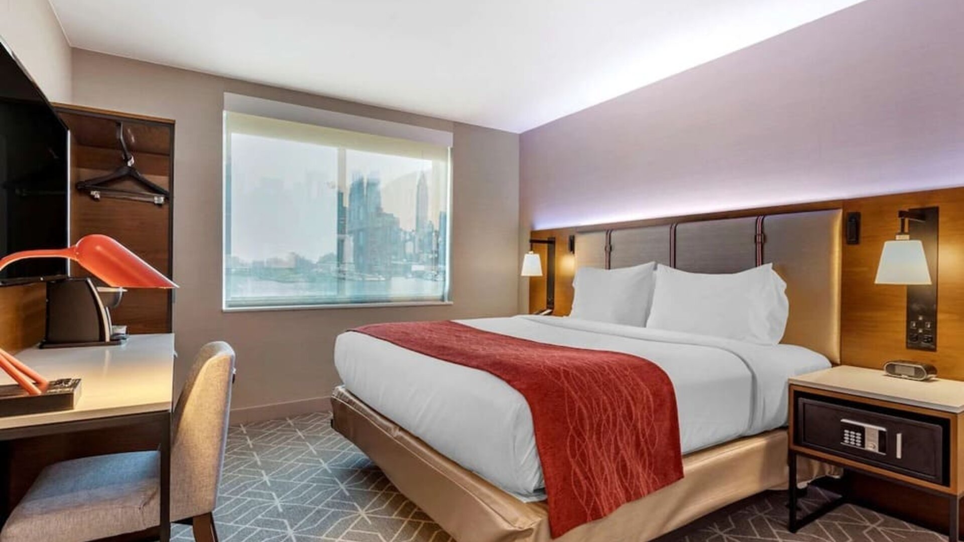 Day use room with work desk and natural light at Comfort Inn JFK Airport.