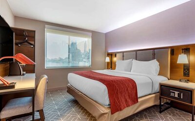 Day use room with work desk and natural light at Comfort Inn JFK Airport.