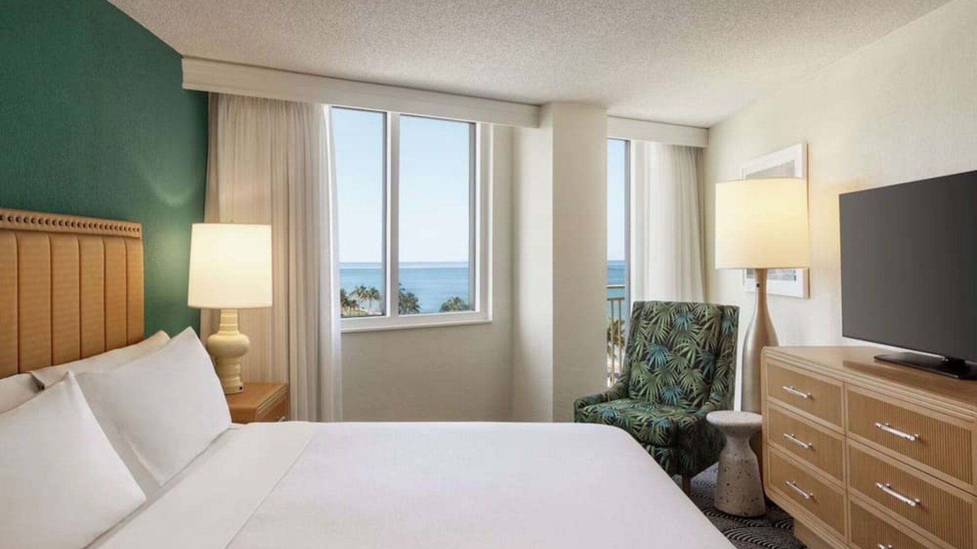 Romantic king room with TV at Embassy Suites By Hilton Deerfield Beach Resort & Spa.