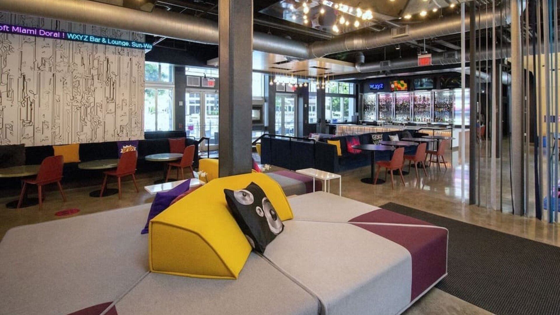 Lobby and seating area at Aloft Miami Doral.
