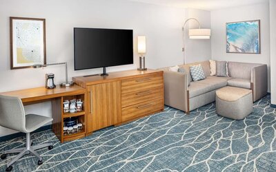 Day room with TV and work space at Hyatt Place Waikiki Beach.