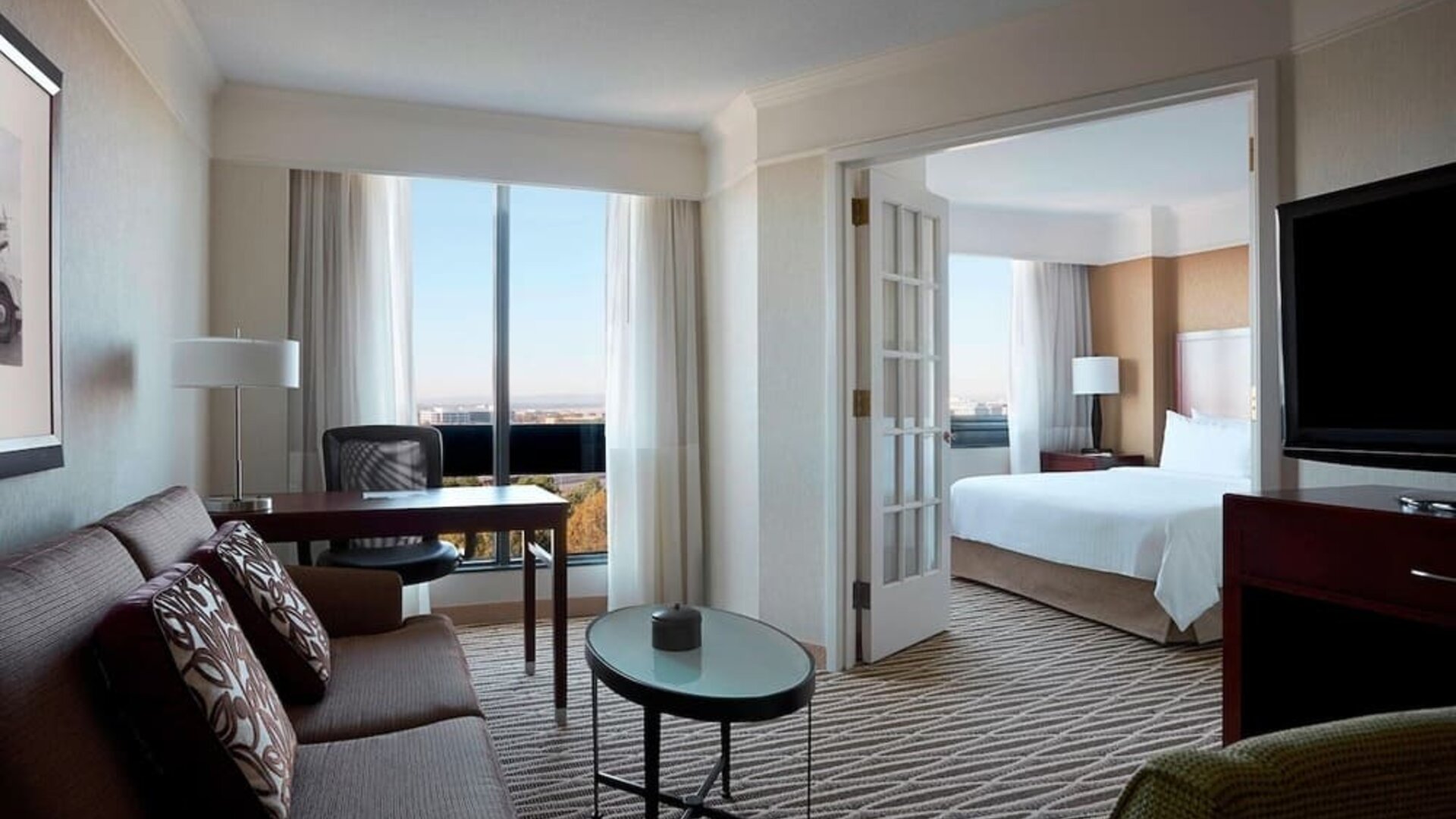 Spacious day use room with lounge and TV at Washington Dulles Marriott Suites.