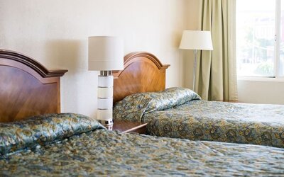 Day room with two queen beds at Stardust Motel Redding.