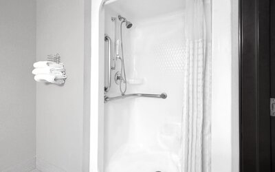 Guest bathroom with shower at Super 8 Bedford DFW Airport West.  